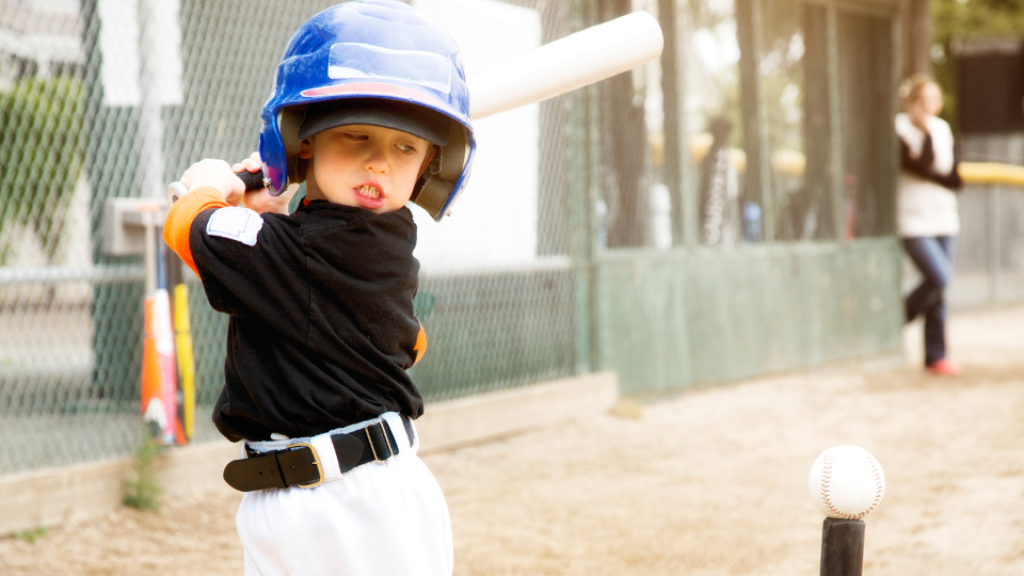 Tee ball player winding up swing.