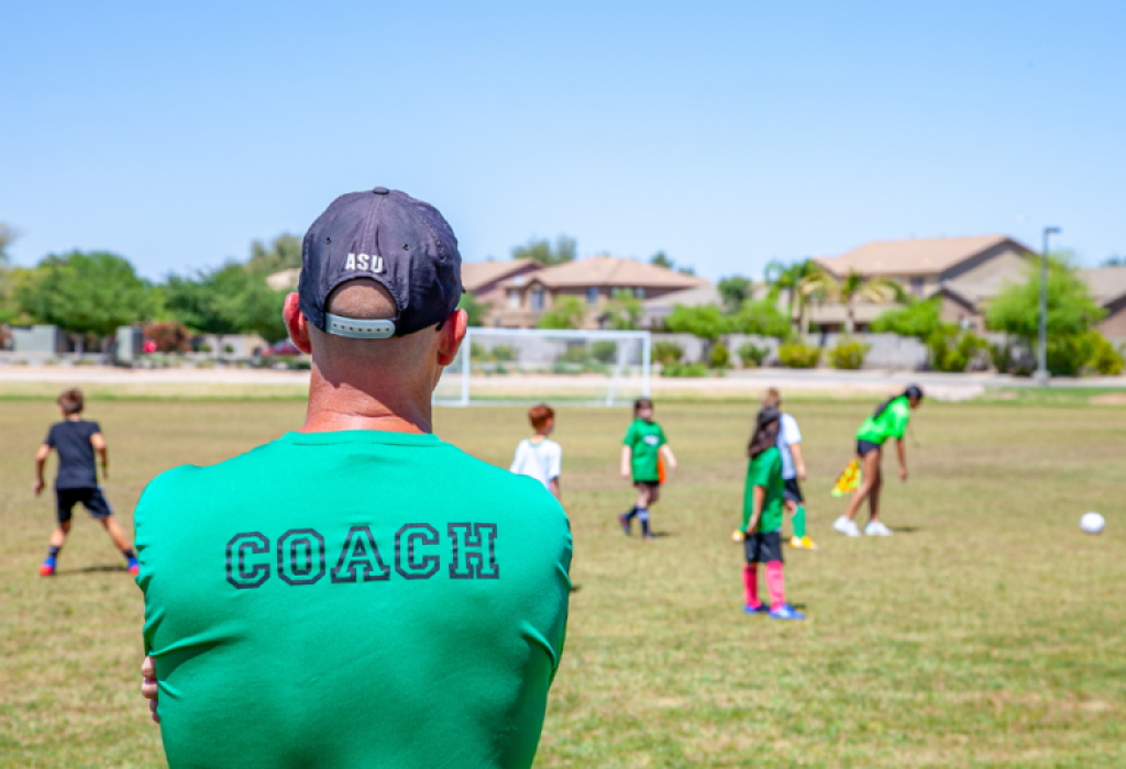 Coach looking out on soccer field.