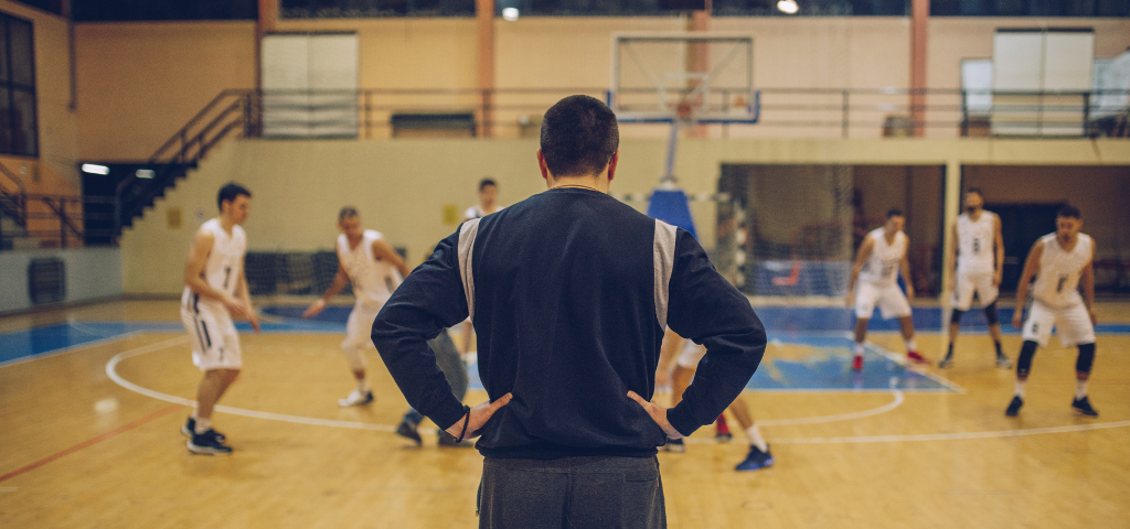 Coach overlooking basketball court.