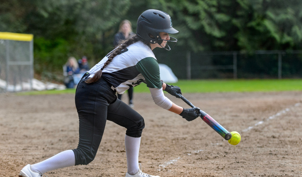 Softball player bunting.