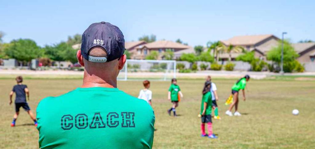Soccer coach looking out on field.