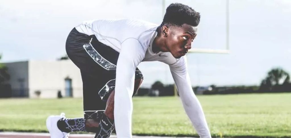 Track and field athlete in ready position.