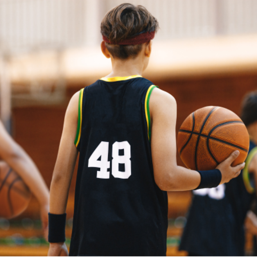Basketball player holding ball.