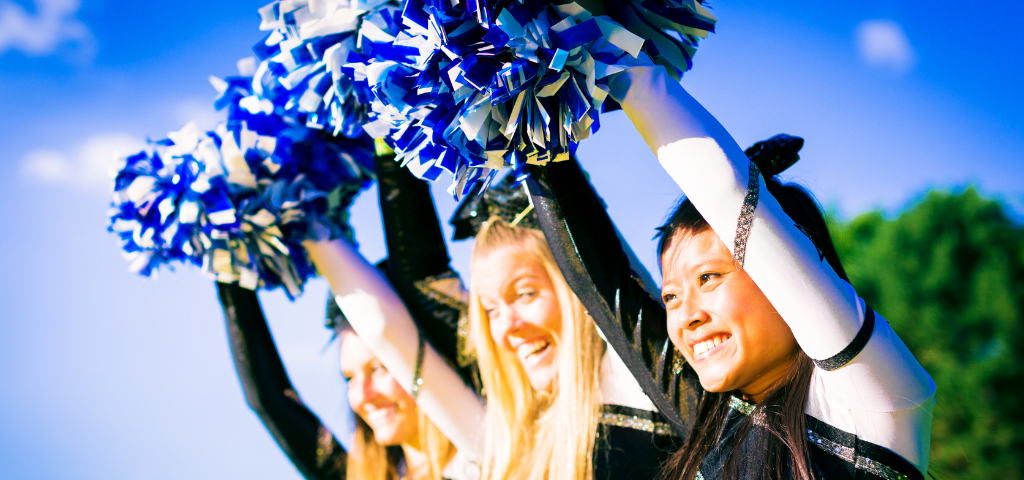Cheerleaders with pom poms.