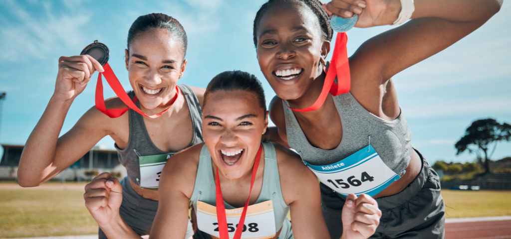 Track & field athletes holding medals.
