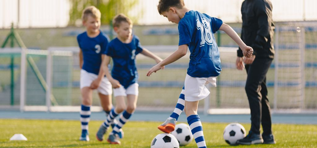 Youth soccer player toe touching ball.