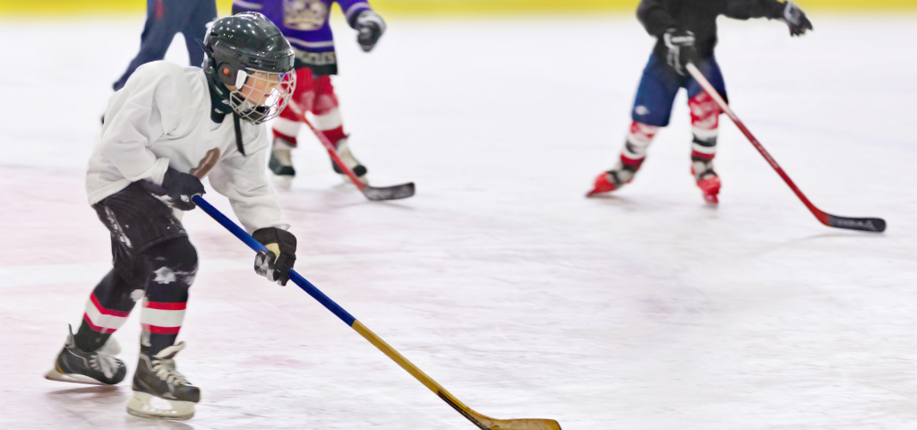 Youth hockey players on ice.