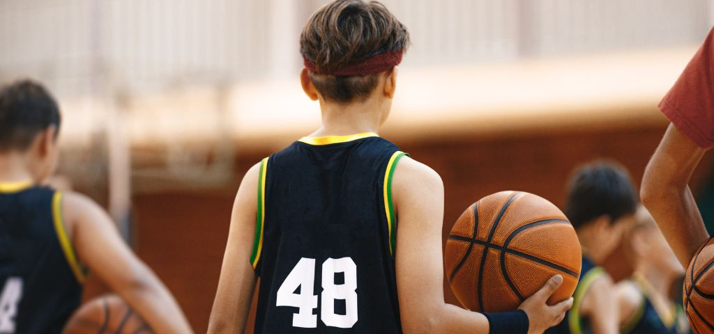 Youth basketball player with ball in hand.