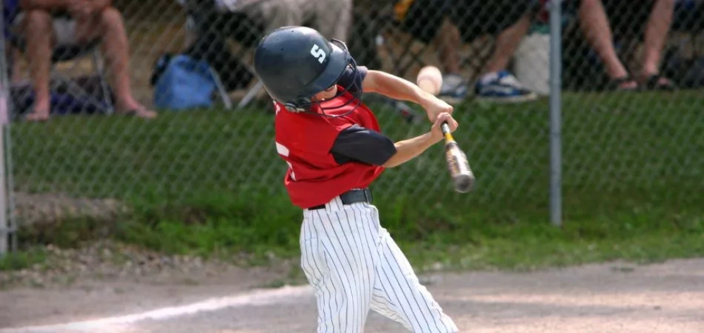 Baseball player mid swing.