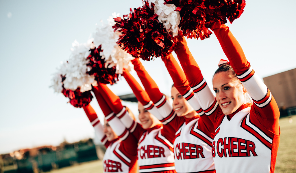 Cheerleaders holding up pom poms.