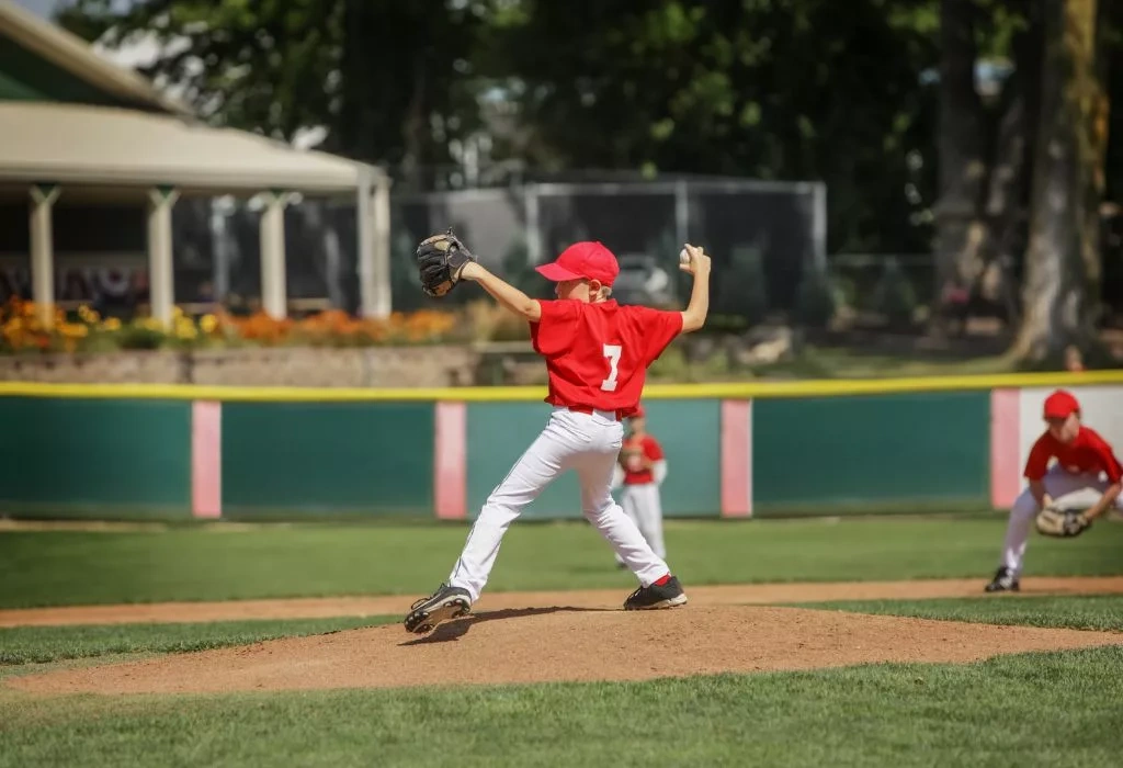 Youth baseball player about to throw a ball.