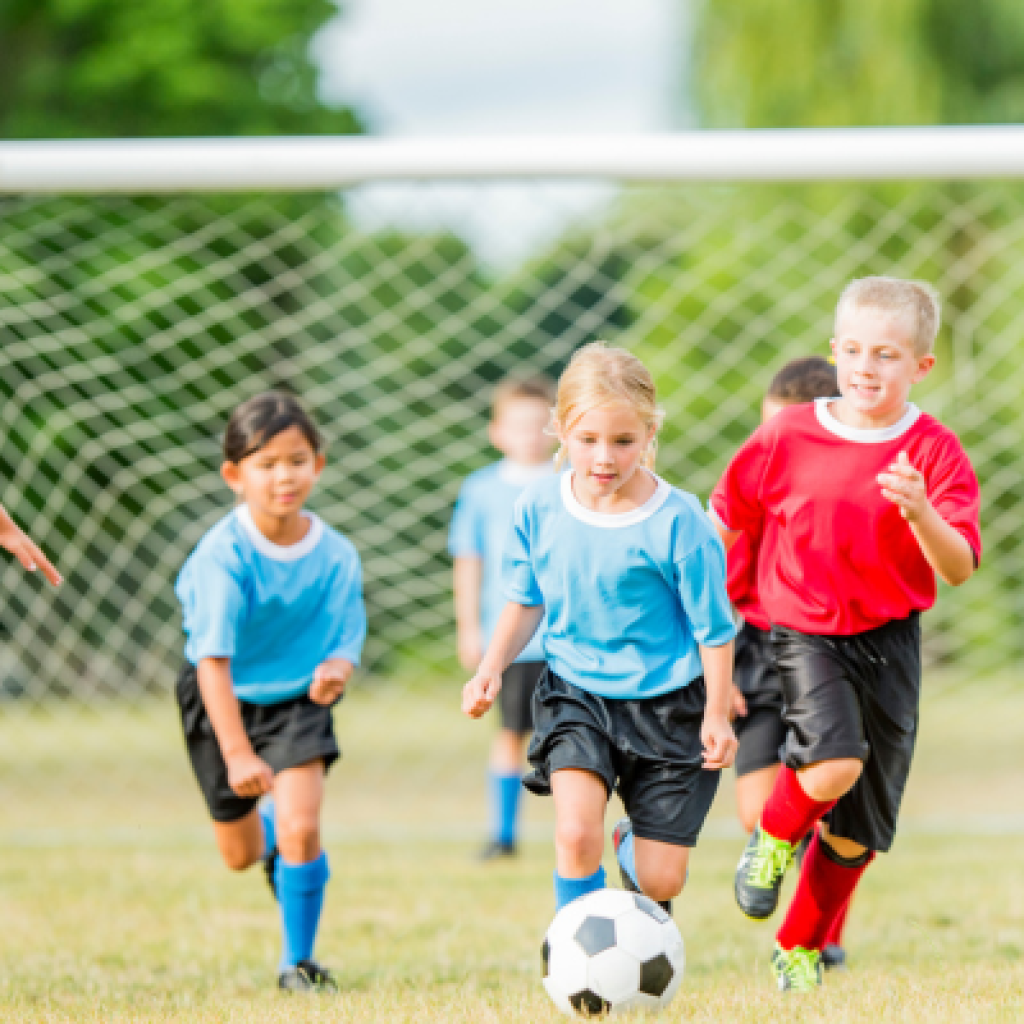 Soccer player dribbling ball.