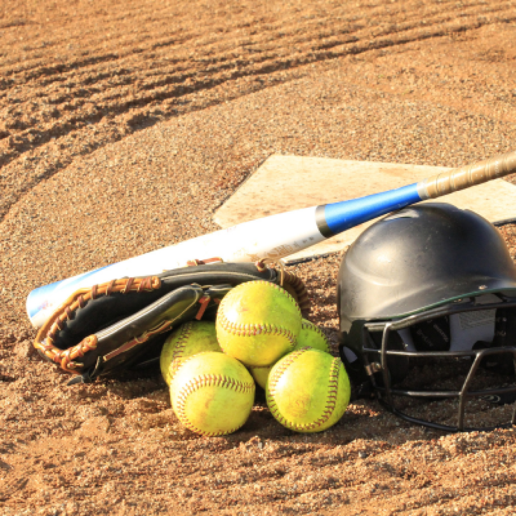 Softball equipment on ground.