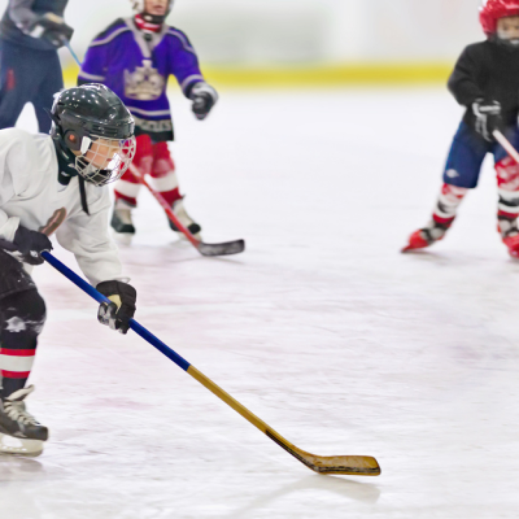 Hockey player skating with puck.