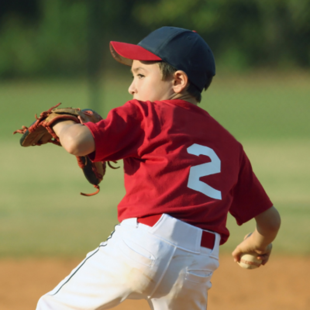 Baseball player winding up throw.