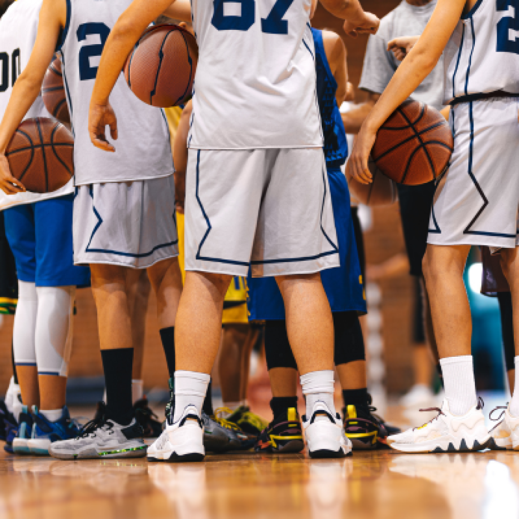 Basketball players in huddle.
