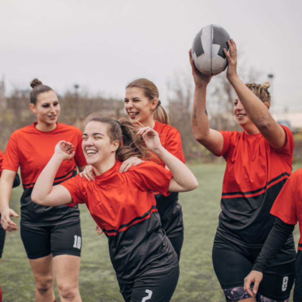Rugby players celebrating on field.