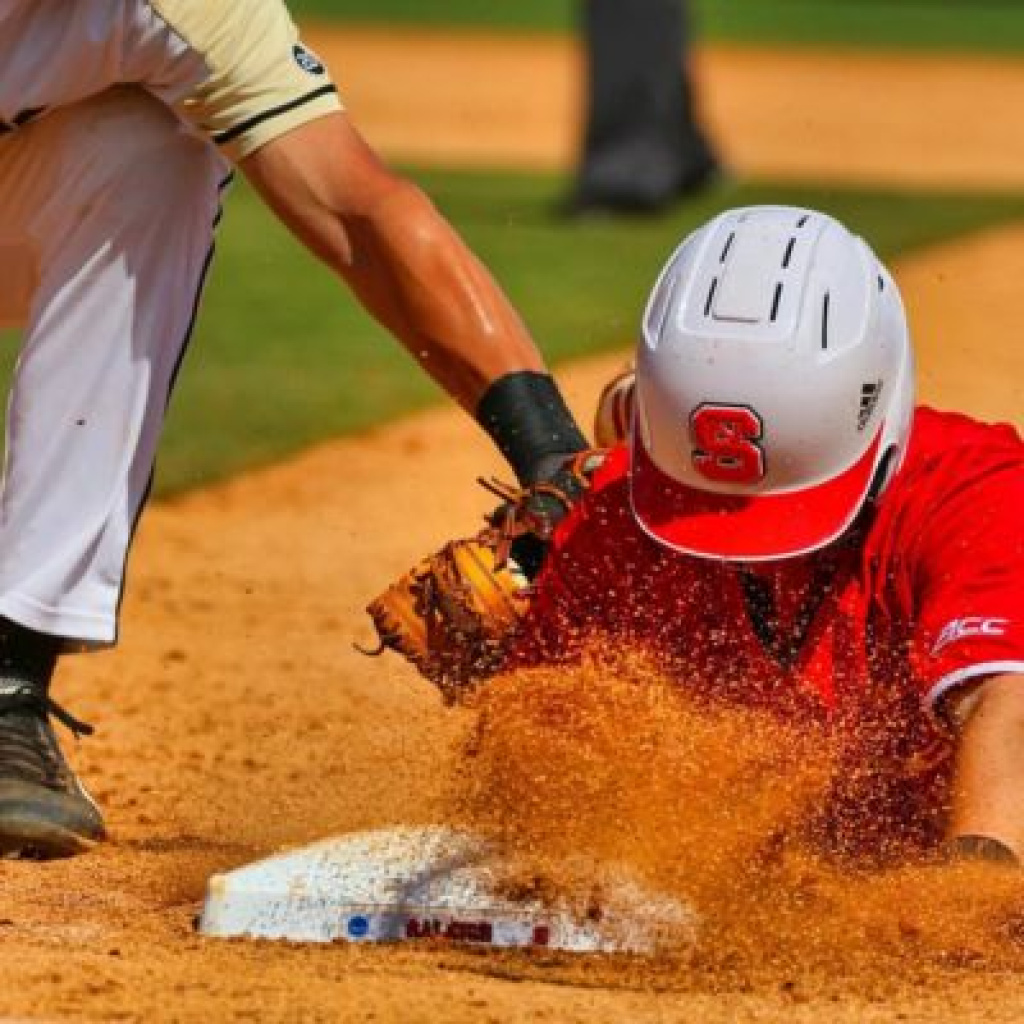 Baseball player sliding on ground.