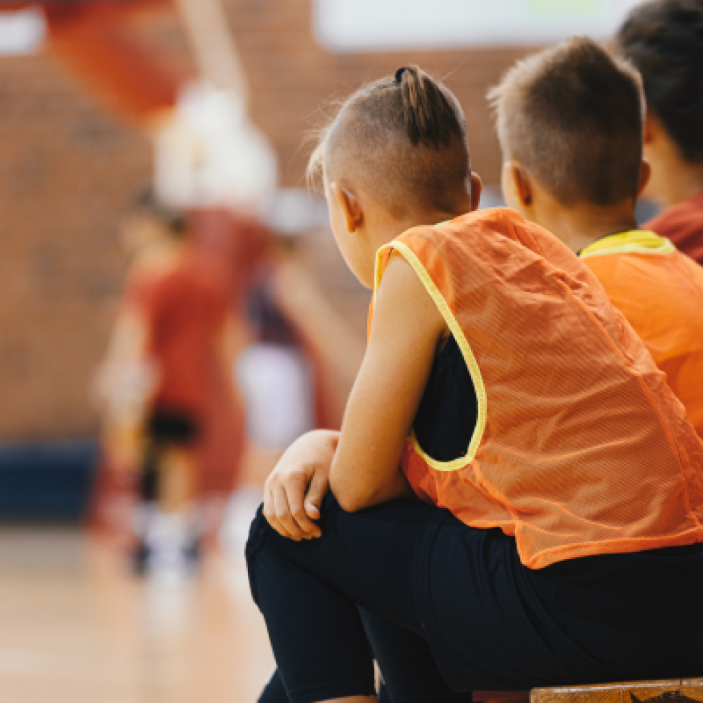 Basketball player looking out onto court.