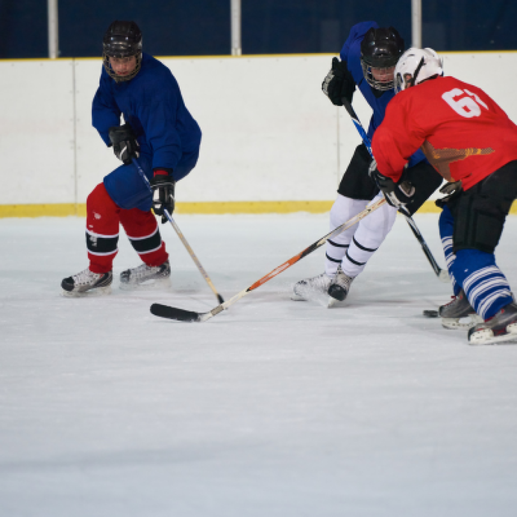 Hockey players trying to gain possession of puck.