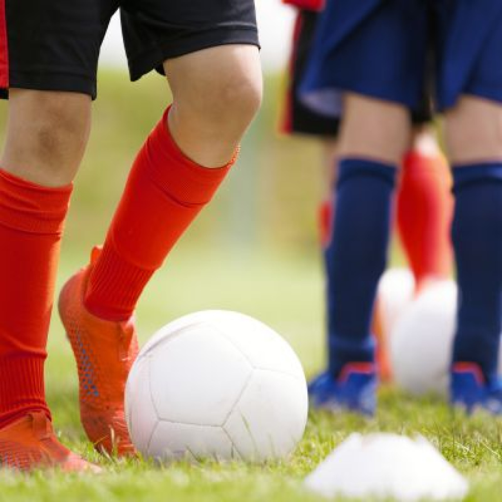 Soccer player with foot under ball.