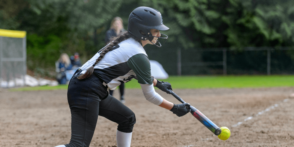 softball player bunting ball.