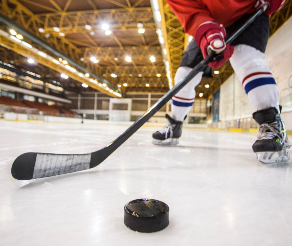 Hockey player about to shoot puck.