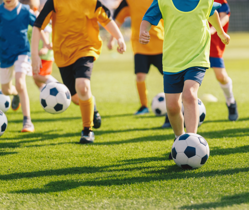 Kids running on soccer field.