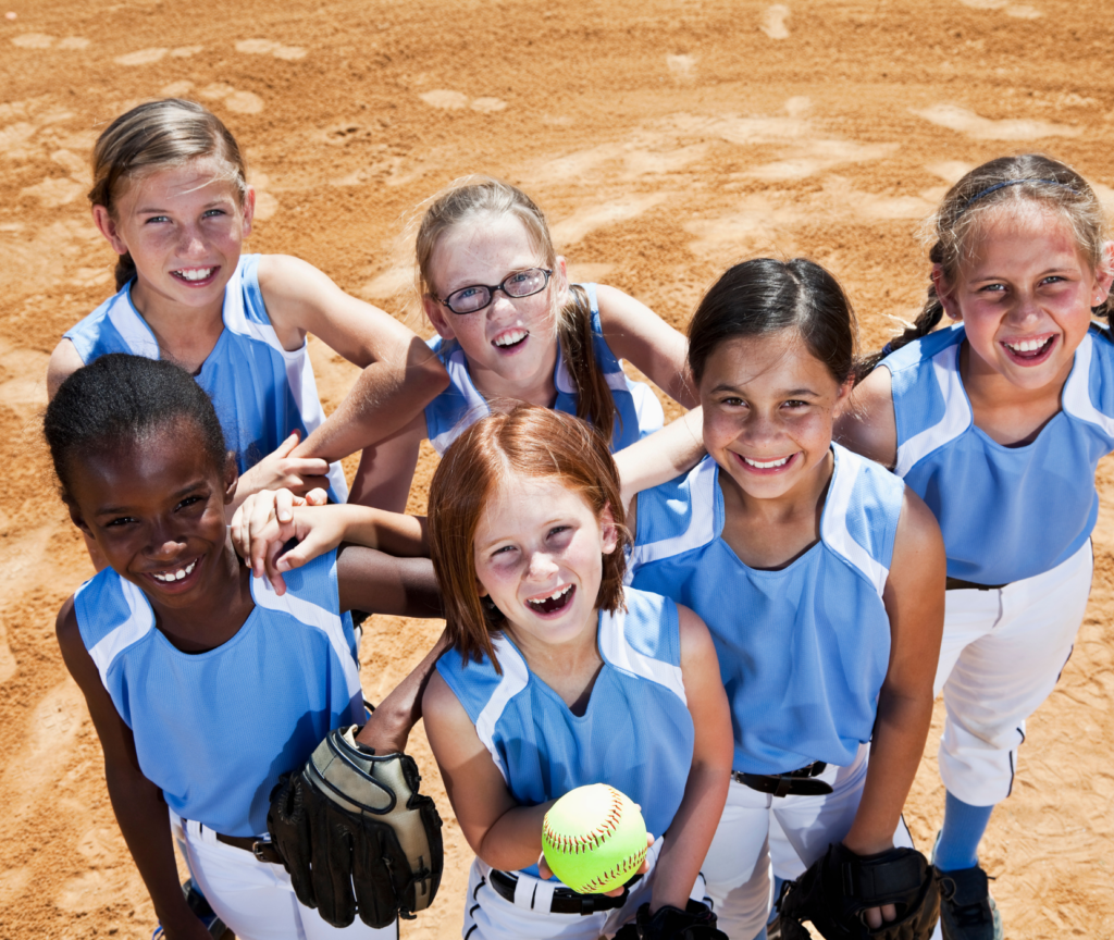 Softball players smiling in group photo.