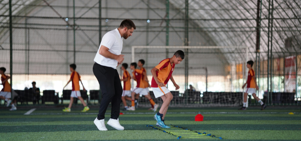 Coach looking over soccer player.