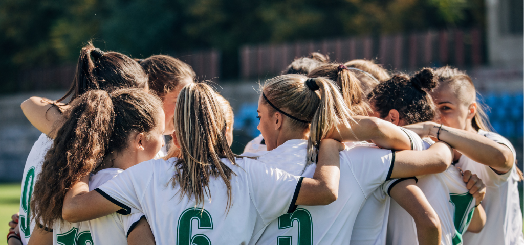 Soccer players in huddle.