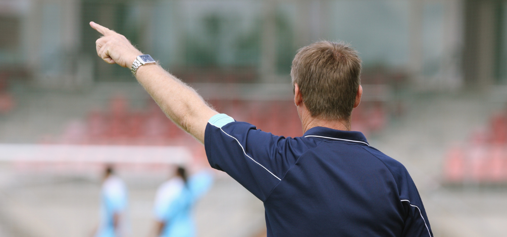 Coach making a call on the field.
