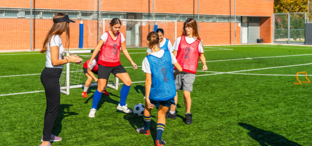 Soccer players mid dribble.